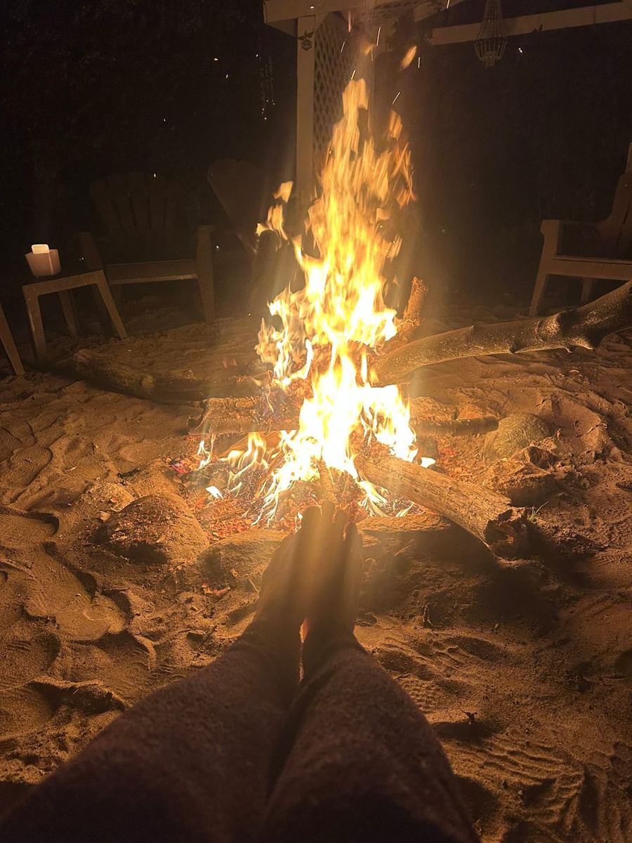 Bare feet warming by the bonfire